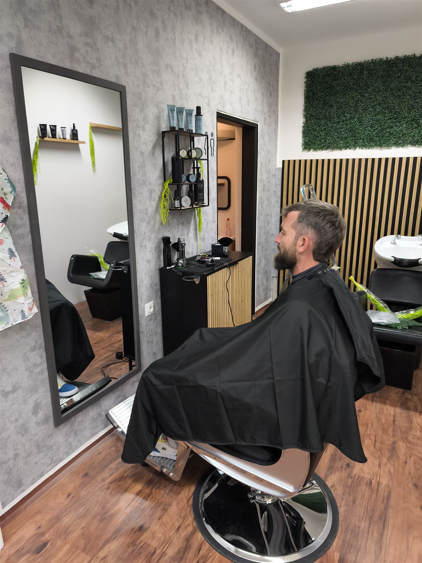 Klient v barberském křesle před zrcadlem